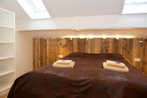 a bedroom with a bed with two towels on it at Landhaus Kössel in Füssen
