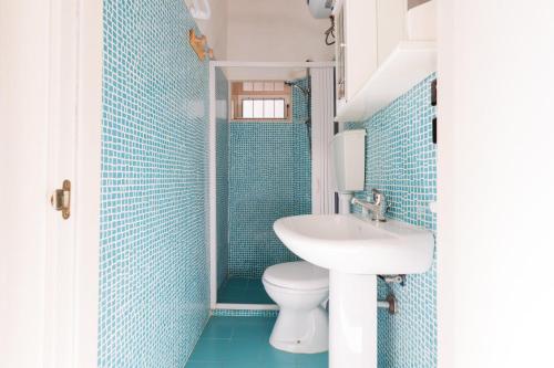 a bathroom with a toilet and a sink at Villa Tabu' by BarbarHouse in Porto Cesareo