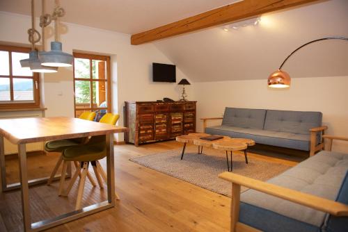 a living room with a couch and a table at Landhaus Kössel in Füssen