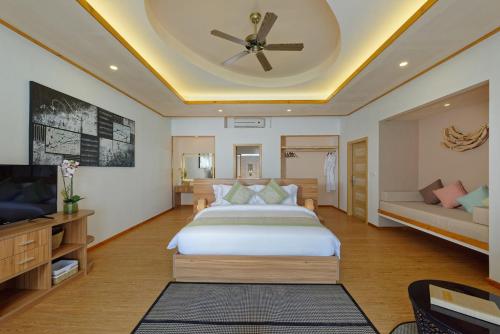 a bedroom with a large bed and a ceiling at Brennia Kottefaru Maldives in Raa Atoll