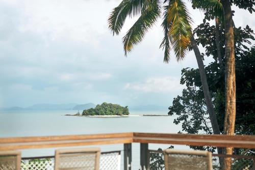 a view of an island in the ocean from a deck at Island Escape Burasari in Phuket Town