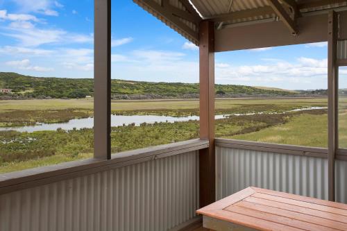 a view from the porch of a house with a table at Otway coastal villas in Princetown