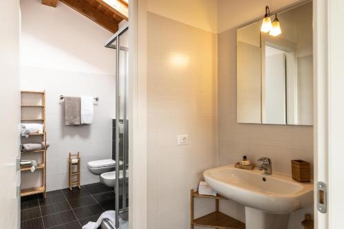a bathroom with a sink and a toilet at Il Giardino Di Lory in Vercana
