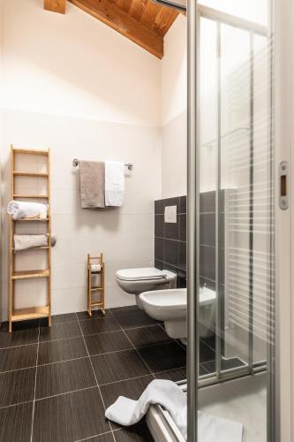 a bathroom with a toilet and a glass shower at Il Giardino Di Lory in Vercana