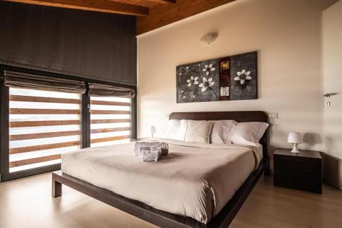 a bedroom with a large bed and a window at Il Giardino Di Lory in Vercana