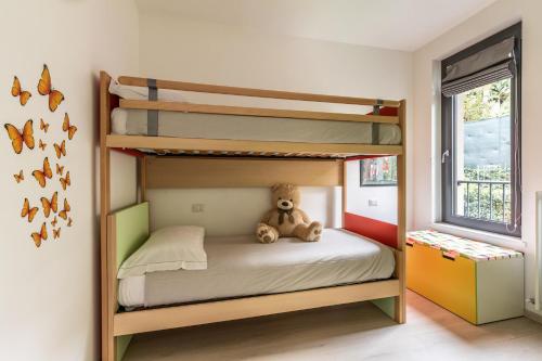 a teddy bear sitting on a bunk bed in a room at Il Giardino Di Lory in Vercana