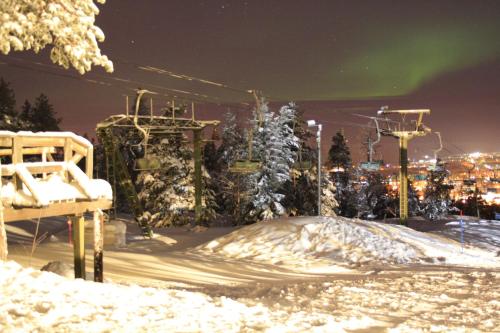 a ski lift in the snow at night at Tilhi Chalet in Rovaniemi