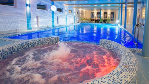 a large pool with a hot tub in a hotel at Tuchkovo SPA hotel in Tuchkovo