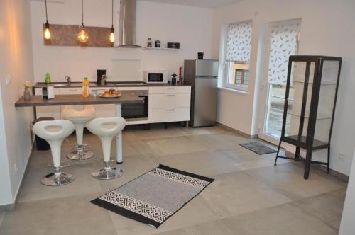 a kitchen with a counter and some stools in it at Villa Vauban in Sélestat