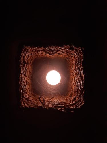 a light in a cave with a hole in it at The Loft in Midigama