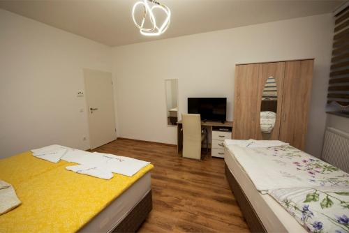 a bedroom with two beds and a television in it at Design Apartments 1 in Dortmund