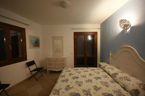 a bedroom with a bed and a dresser at Le 9 Gocce Seaview Apartment in Palau