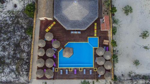 an overhead view of a house with a pool and trees at LAGUNA BEACH in Morondava