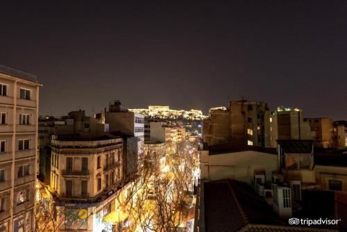 a view of a city at night with lights at Cecil Hotel in Athens