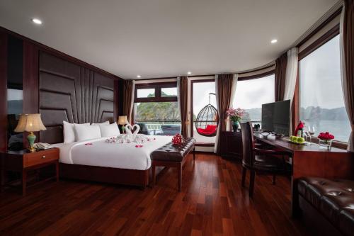 a bedroom with a bed and a desk with a computer at Dora Cruise by HAG in Ha Long
