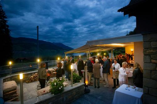 a crowd of people standing outside of a building at night at Landgasthof Zollhaus in Sachseln