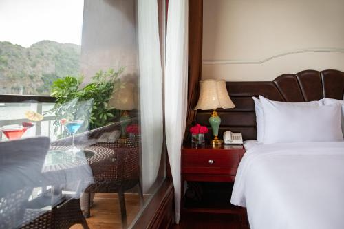 a hotel room with a bed and a window at Dora Cruise by HAG in Ha Long