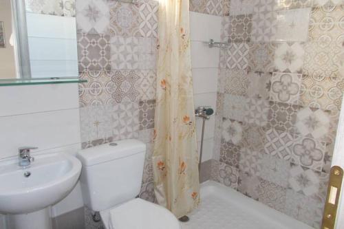 a bathroom with a white toilet and a sink at Square 's House in Lefkada