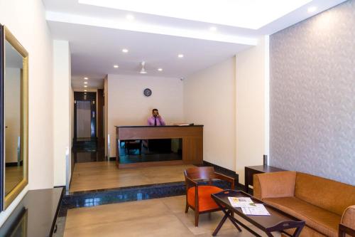 a woman standing at a desk in a room at Hotel Dreamland in Pune