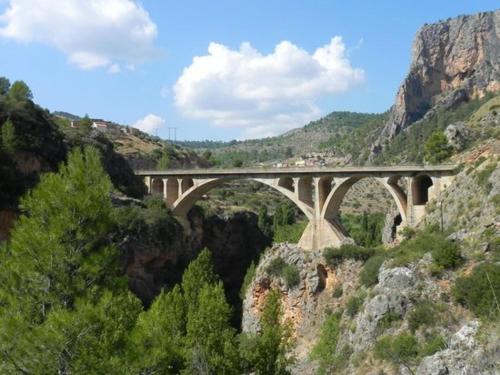 a bridge over a canyon with a mountain at Casas Rurales Balcón de las Mayas in Ayna