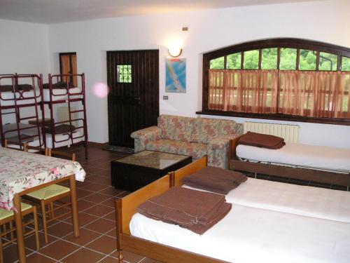 a living room with bunk beds and a couch at Dortoir de Ollomont in Ollomont