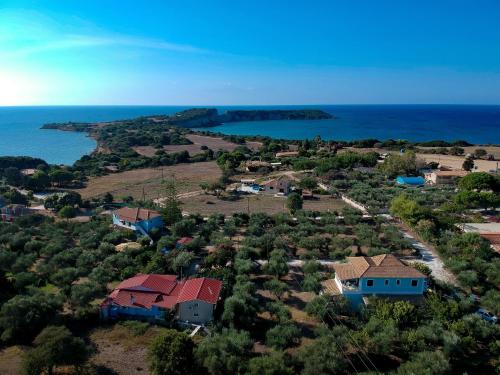 an aerial view of a house and the ocean at Areti Orfeas Studios in Vasilikos