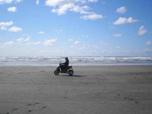 a person riding a motorcycle on the beach at Historic 1920s Cabin in Long Beach
