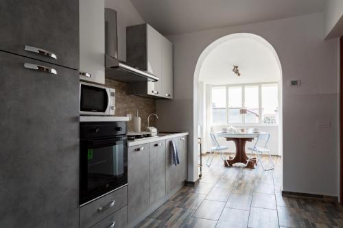 a kitchen with a sink and a table with a microwave at C'era una volta room in Case Nuove