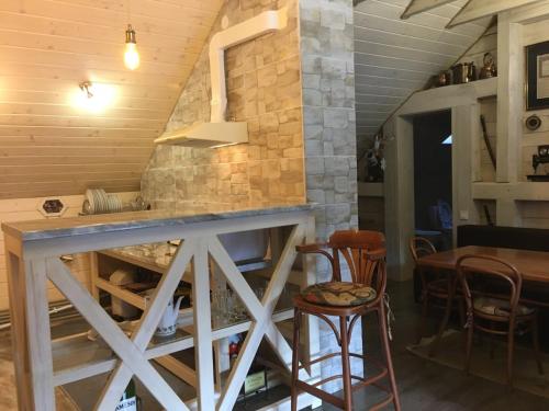 a kitchen with a counter and a table and chairs at Вілла Лісова комфорт in Skhidnitsa