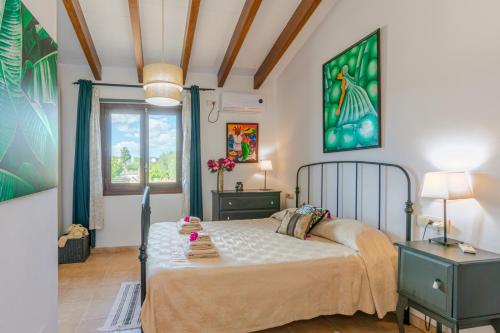 a bedroom with a bed and a window at Casa Baix in Sineu