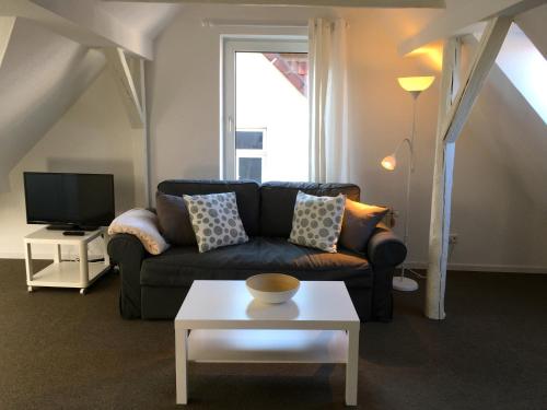 a living room with a couch and a tv at Studio Emilie in Detmold