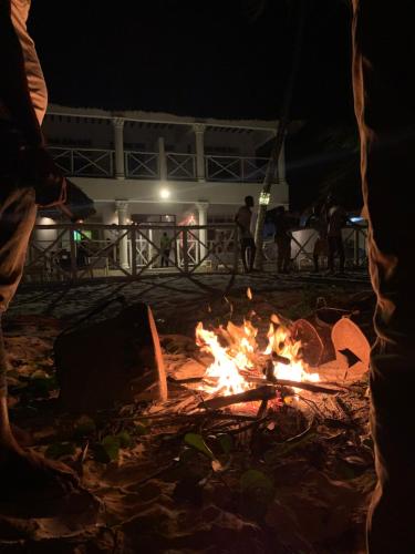 a fire pit on the beach at night at The African Paradise Beach Hotel in Bwejuu