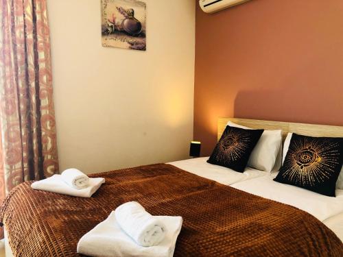 a hotel room with two beds with towels on them at Hotel Malta in Mostar
