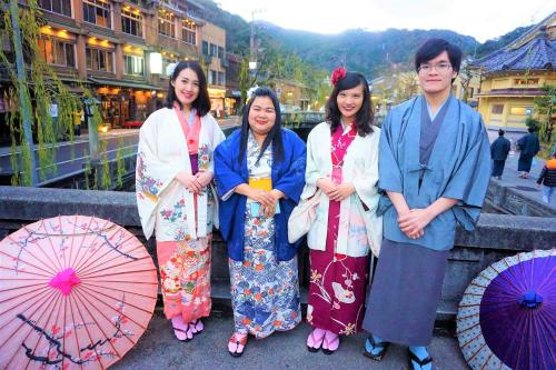 a group of people posing for a picture with umbrellas at Morizuya in Toyooka