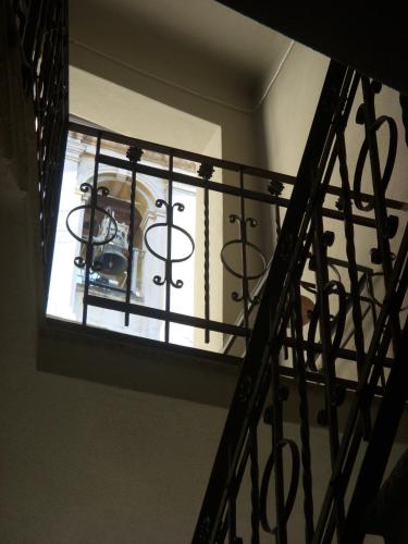 a spiral staircase with a window in a building at Locanda San Bernardo in Vigevano