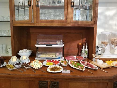 a table with plates of food on a counter at Hotel Restaurant Toscana Naumburg in Naumburg