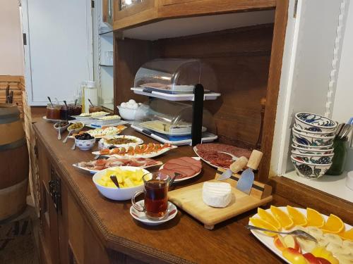 a counter with many plates of food on it at Hotel Restaurant Toscana Naumburg in Naumburg