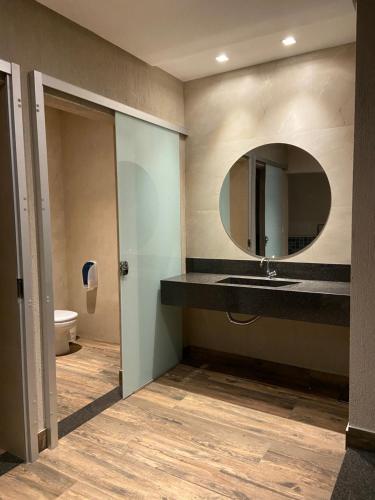 a bathroom with a sink and a mirror at Pousada Viver Capitólio in Capitólio