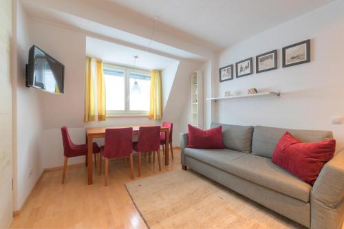 a living room with a couch and a table at Aparthotel Acksteiner in Sankt Anton am Arlberg