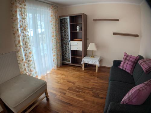 a living room with a couch and a table at Appartementhaus Riepler in Bad Gastein