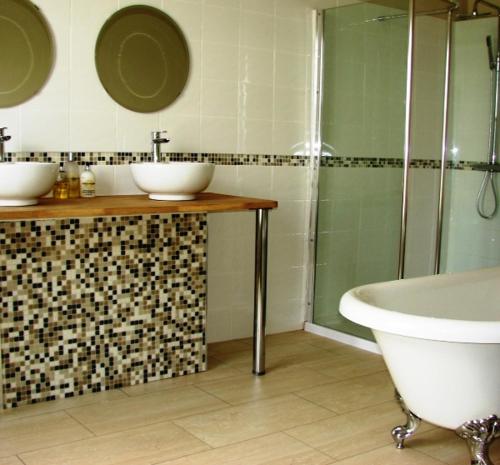 a bathroom with two sinks and a shower and a tub at The Clock House in Brewood