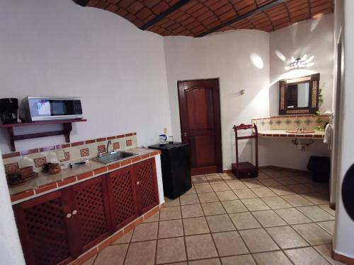 a room with a kitchen with a sink and a mirror at Villas Vista Suites Sayulita in Sayulita