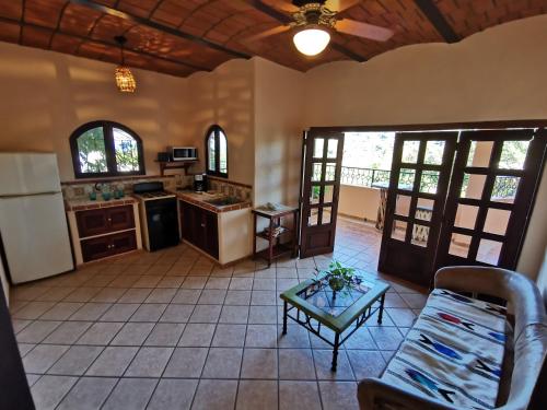 a kitchen with a couch and a table in a room at Villas Vista Suites Sayulita in Sayulita