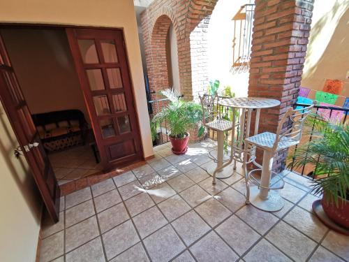 a patio with a table and chairs and a door at Villas Vista Suites Sayulita in Sayulita