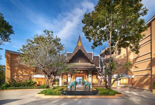 a building with a statue in front of it at Amari Vogue Krabi - SHA Extra Plus in Tab Kaek Beach