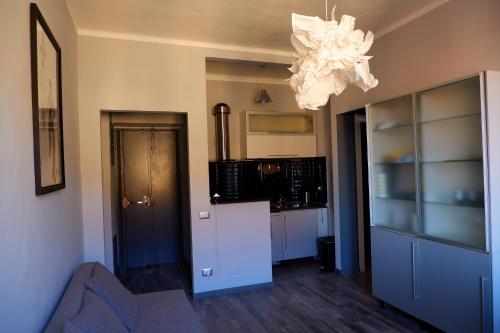 a kitchen with a couch and a chandelier at Ziggy House in Turin