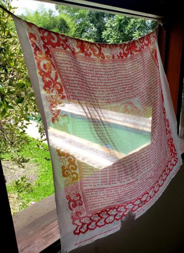 a window with a red and white curtain at Toca da Capuava in Cotia