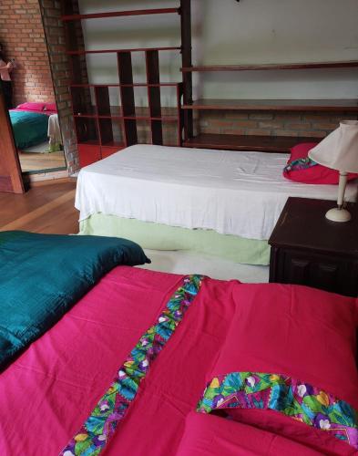 two beds sitting next to each other in a room at Toca da Capuava in Cotia
