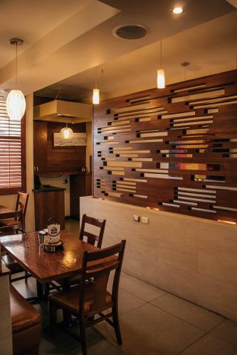 a dining room with a table and a wooden wall at Best Western Cumbres Inn Cd. Cuauhtemoc in Cuauhtémoc