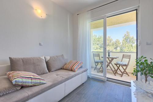 a living room with a couch and a patio at Apartments Gilly 2 in Premantura